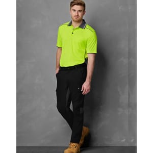 Work pants in black with rip-stop fabric, paired with a bright yellow short-sleeve polo shirt. Features a logo.