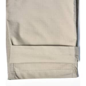 A pair of light khaki Rip-Stop poly/cotton stretch work pants with a cuffed hem. Features a logo.