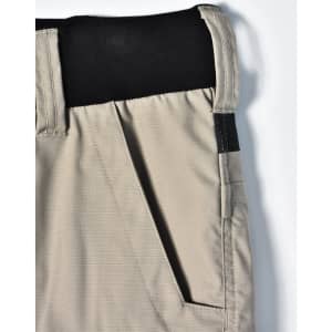 A pair of beige work shorts with a black waistband and pockets, featuring a logo on the side.