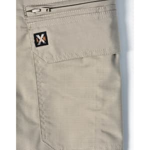 A pair of beige work shorts featuring a zip pocket and a logo patch. The fabric has a rip-stop texture.
