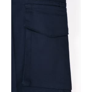 A close-up of navy work shorts featuring a pocket and a logo. The fabric appears durable and stretchy.