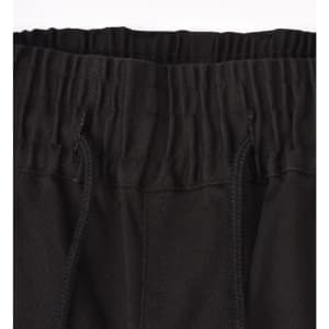 A close-up of unisex cotton stretch drill cuffed work pants in black, featuring an elastic waistband and drawstring.