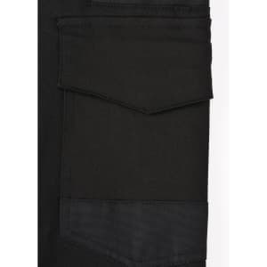 A close-up of black cotton stretch drill cuffed work pants, featuring pockets and a logo.
