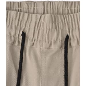 A pair of unisex cotton stretch drill cuffed work pants in a light beige colour with an elastic waistband and drawstring.