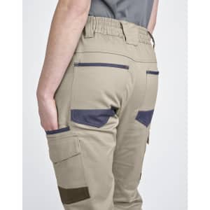 Unisex cotton stretch drill cuffed work pants in beige with navy accents and pockets, featuring an elastic waistband.