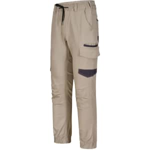 Unisex cotton stretch drill cuffed work pants in beige with pockets and a drawstring waist. Features branding details.