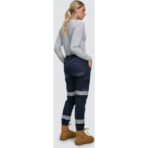 Cotton stretch drill cuffed work pants in navy with reflective tapes, worn with a grey long-sleeve top and boots.