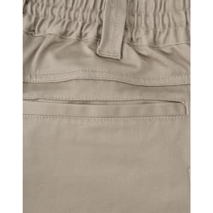 A close-up of beige unisex cotton stretch drill work shorts, featuring an elastic waistband and a pocket.