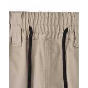 A pair of beige unisex cotton stretch drill work shorts featuring an elastic waistband and black drawstring.
