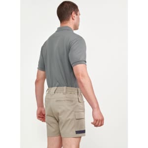 Unisex cotton stretch drill short work shorts in beige, paired with a grey polo shirt, shown from the back.