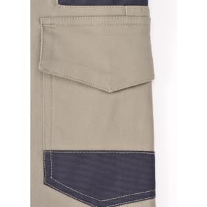A close-up of unisex cotton stretch drill work shorts in khaki with navy blue detailing and pockets. Includes a logo.