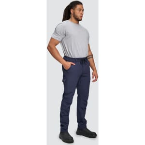 Flexi work pants in navy blue worn by a person standing, paired with a grey t-shirt and black shoes.
