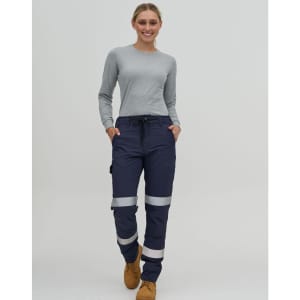 Navy water-repellent flexi work pants with reflective tape, worn by a person in a grey long-sleeve top.