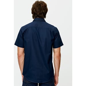 A navy short-sleeved shirt with a back view, featuring a logo on the upper back.