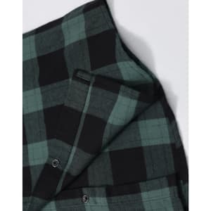A unisex flannel plaid shirt featuring green and black checks, with buttons and a small pocket detail.