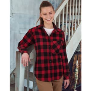 A unisex flannel plaid shirt in red and black, featuring a button-up design and a pocket, worn by a smiling model.