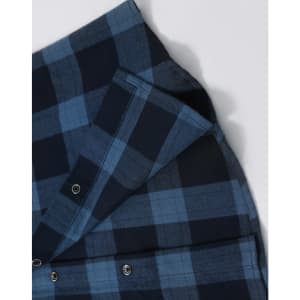 A unisex flannel plaid shirt in dark blue tones, featuring button-up closure and a visible logo.