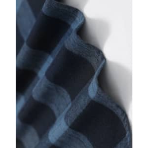 A close-up of a navy blue and black plaid flannel fabric, showcasing its soft texture and pattern.