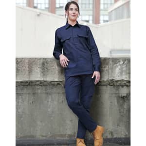 A navy long-sleeve work shirt with a closed front and two chest pockets, worn by a model. The model is leaning against a wall.