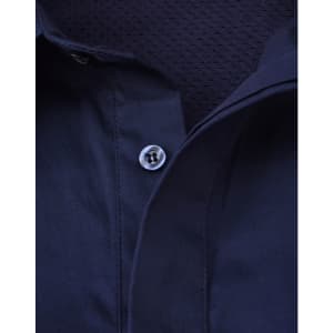 A navy blue long sleeve work shirt with a closed front and mesh interior. It features a button at the collar and has a branded logo.