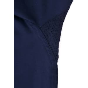A close-up of a navy blue work shirt featuring a mesh panel for ventilation, with stitching details visible.