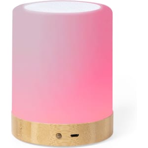 A pink gradient speaker with a bamboo base, featuring a logo and a USB port at the bottom.