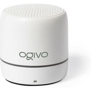 A white compact speaker with a rounded design and a logo on the front. Features a textured top for sound output.