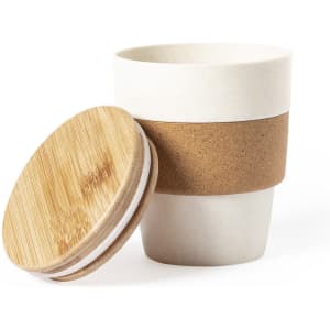A travel mug in off-white with a cork band and a bamboo lid, designed for beverages on the go.