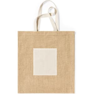 A tan tote bag with an off-white patch, featuring two handles and a simple design.