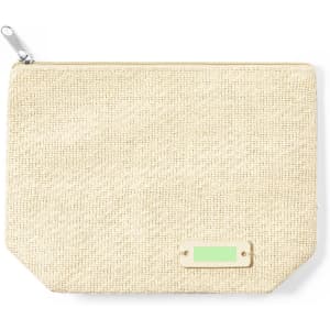 A beige toiletry bag with a textured surface and a small branding tag.