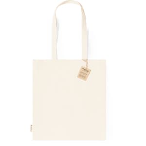 A cream tote bag with shoulder straps, featuring a tag and a simple design. It has a logo on one side.