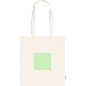 A beige tote bag featuring a green square patch in the centre and a logo on the side.
