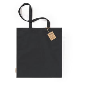A black tote bag with two handles and a tag attached. The bag features a logo.