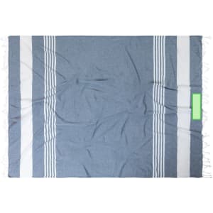 A large, textured beach mat in blue and white, featuring striped patterns and fringed edges. It has a branding logo.