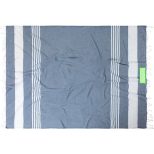 A blue and white striped beach mat with fringing on the edges, featuring a logo in one corner.