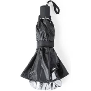 A compact black sunshade with a reflective silver interior, secured with a strap for easy handling.