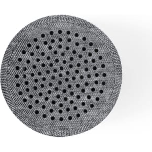 A grey portable speaker with a circular design and perforated surface, featuring a logo on its side.