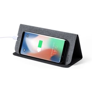 A wireless charger mousepad in grey fabric with a smartphone charging on it. Features a branding logo.