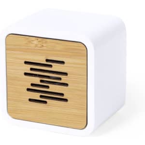 A square speaker featuring a white body and a bamboo front panel, with slotted openings for sound.