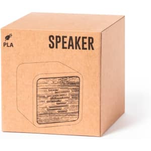 A square, kraft cardboard box featuring a minimalist design of a speaker. The box has a logo and text label.
