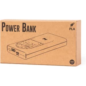 A power bank in a cardboard box, featuring a sleek design with a logo, and labelled with specifications.