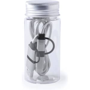 A clear bottle contains a grey and white charging cable, neatly wrapped and secured with an elastic band.
