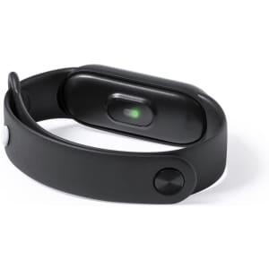 A black smart bracelet with a curved body and a small light indicator. It features a sleek design and a button.