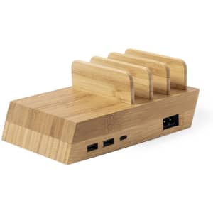 A wireless charger made of bamboo with multiple slots for devices and several USB ports. Features a branding logo.