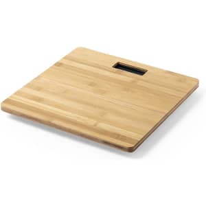 A square bamboo weighing scale with a smooth surface and a rectangular cutout handle.