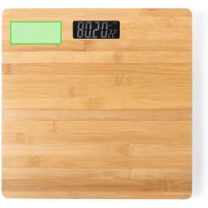 A bamboo weighing scale featuring a digital display and a green area, showcasing a natural wood finish.