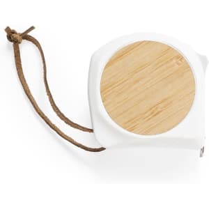 A white tape measure with a bamboo top and a brown leather strap for easy handling.