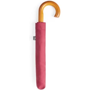 A maroon umbrella with a wooden curved handle, neatly stored in a matching protective cover.