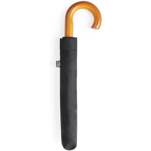 A black umbrella with a wooden curved handle, stored in a black fabric sleeve. It has a logo on the sleeve.