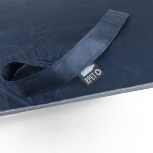A navy blue umbrella featuring a handle with a logo and a tag indicating it’s made from recycled materials.